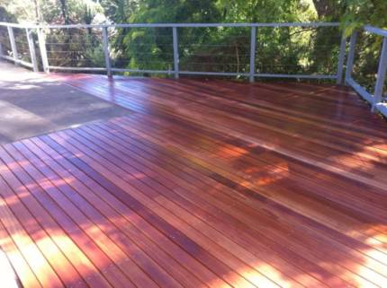 A timber shaded deck with metal balustrades around it, creating a serene area